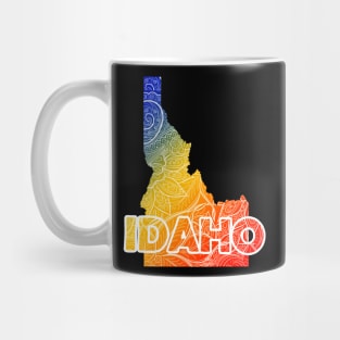 Colorful mandala art map of Idaho with text in blue, yellow, and red Mug